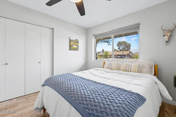 a bedroom with a bed and a chandelier