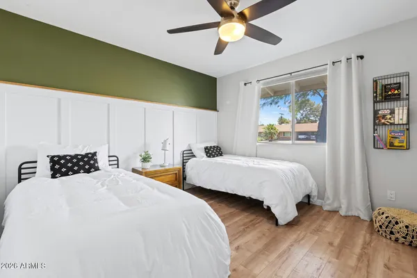 a bedroom with a bed and a flat screen tv