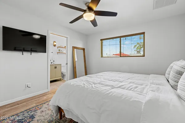 a bedroom with a bed and cabinets