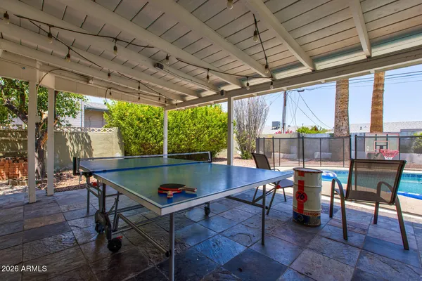a view of a patio with table and chairs
