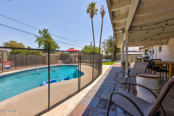 a view of a house with a yard and sitting area