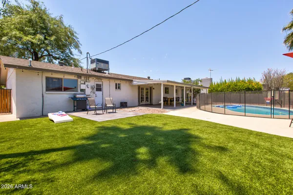 a view of a backyard with sitting area