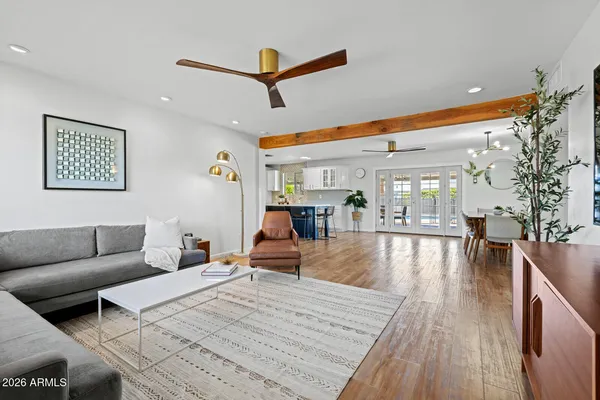 a living room with furniture and a wooden floor