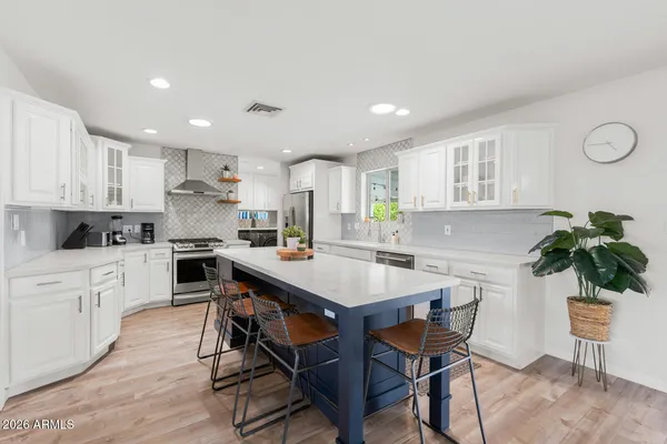 a kitchen with a table and chairs in it