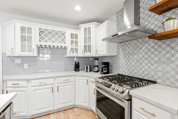 a white stove top oven sitting inside of a kitchen