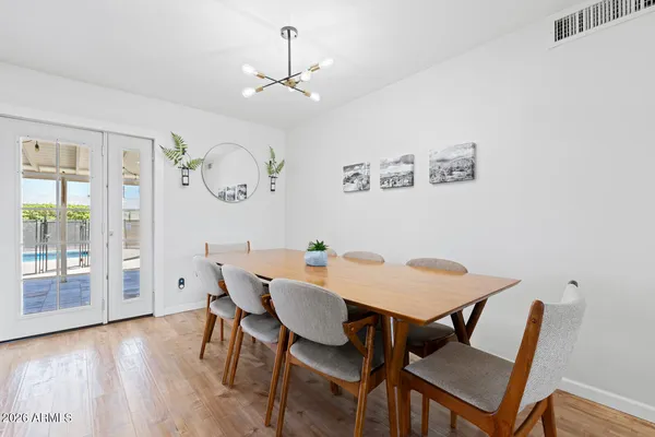 a view of a dining room with furniture wooden floor and a chandelier