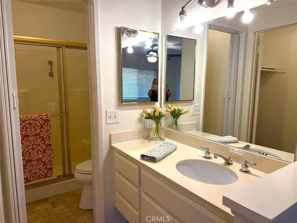 a bathroom with a sink and a mirror with toilet