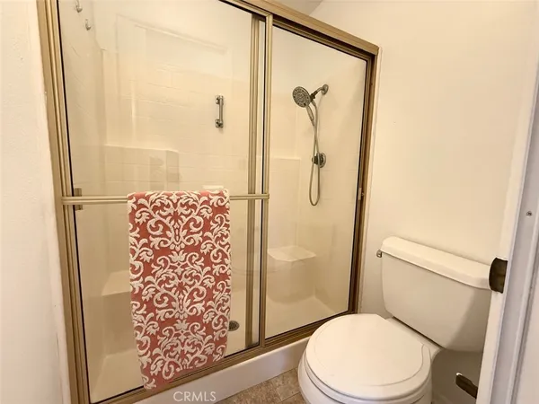 a white toilet sitting next to a bathroom sink