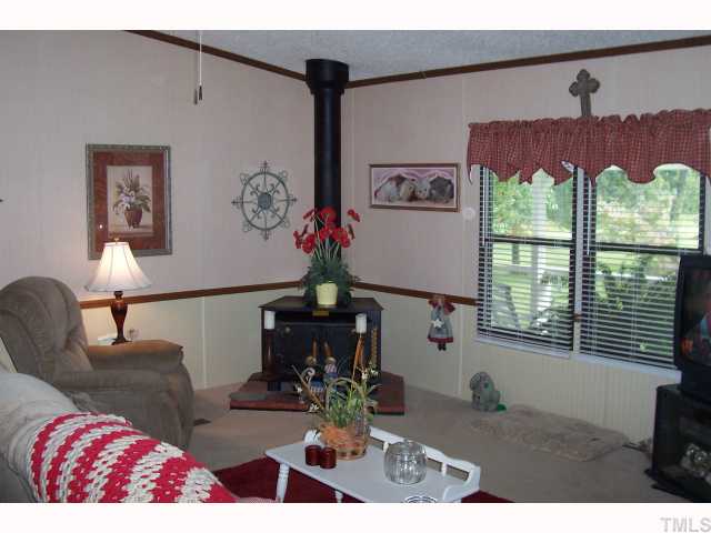 2766 Tarheel Road Benson, NC 27504 - Photo 4 of 8 Living room with wood stove.