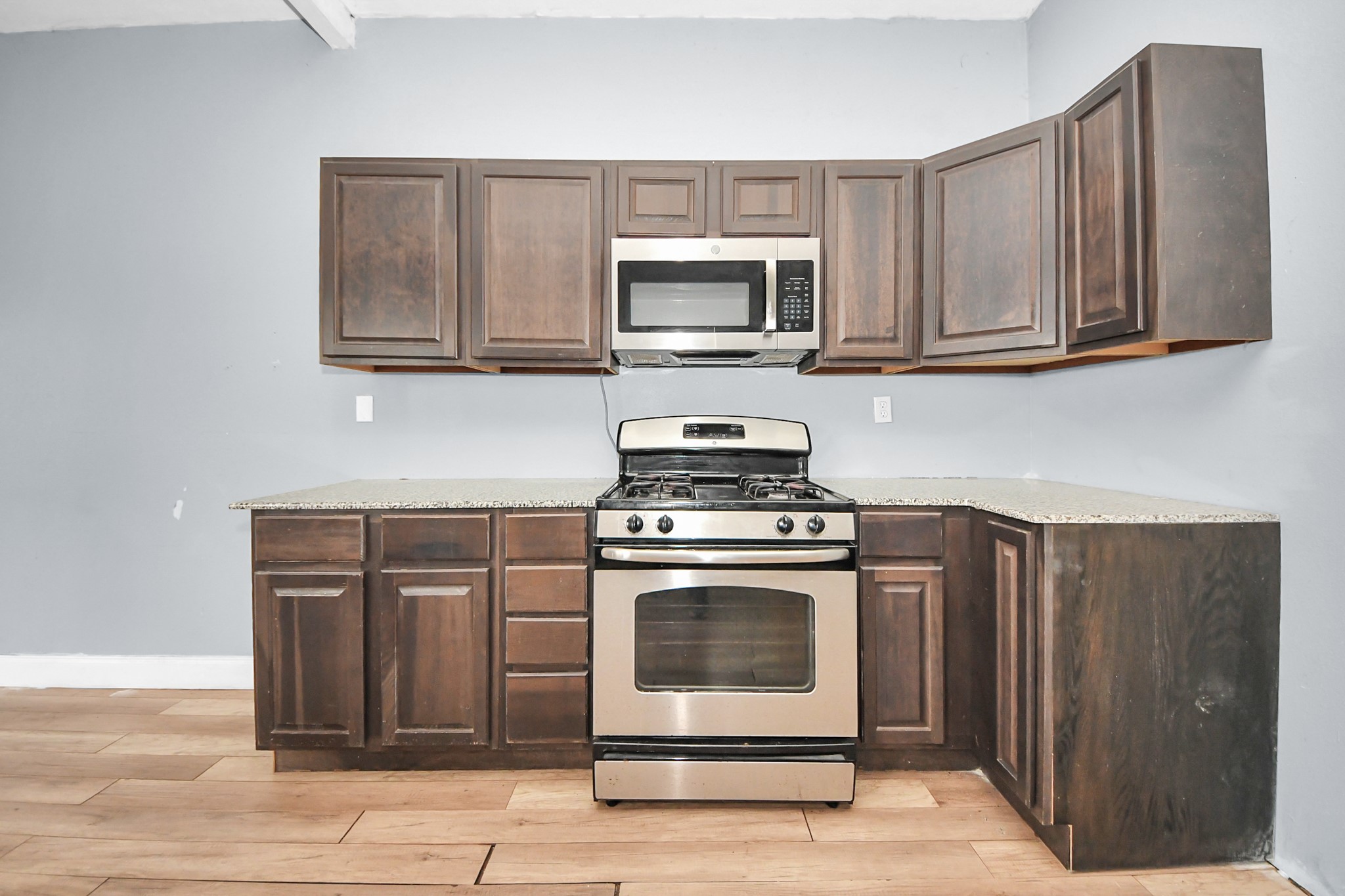 15 High Street Baytown, TX 77520 - Photo 12 of 29 a kitchen with stainless steel appliances granite countertop a stove microwave and sink