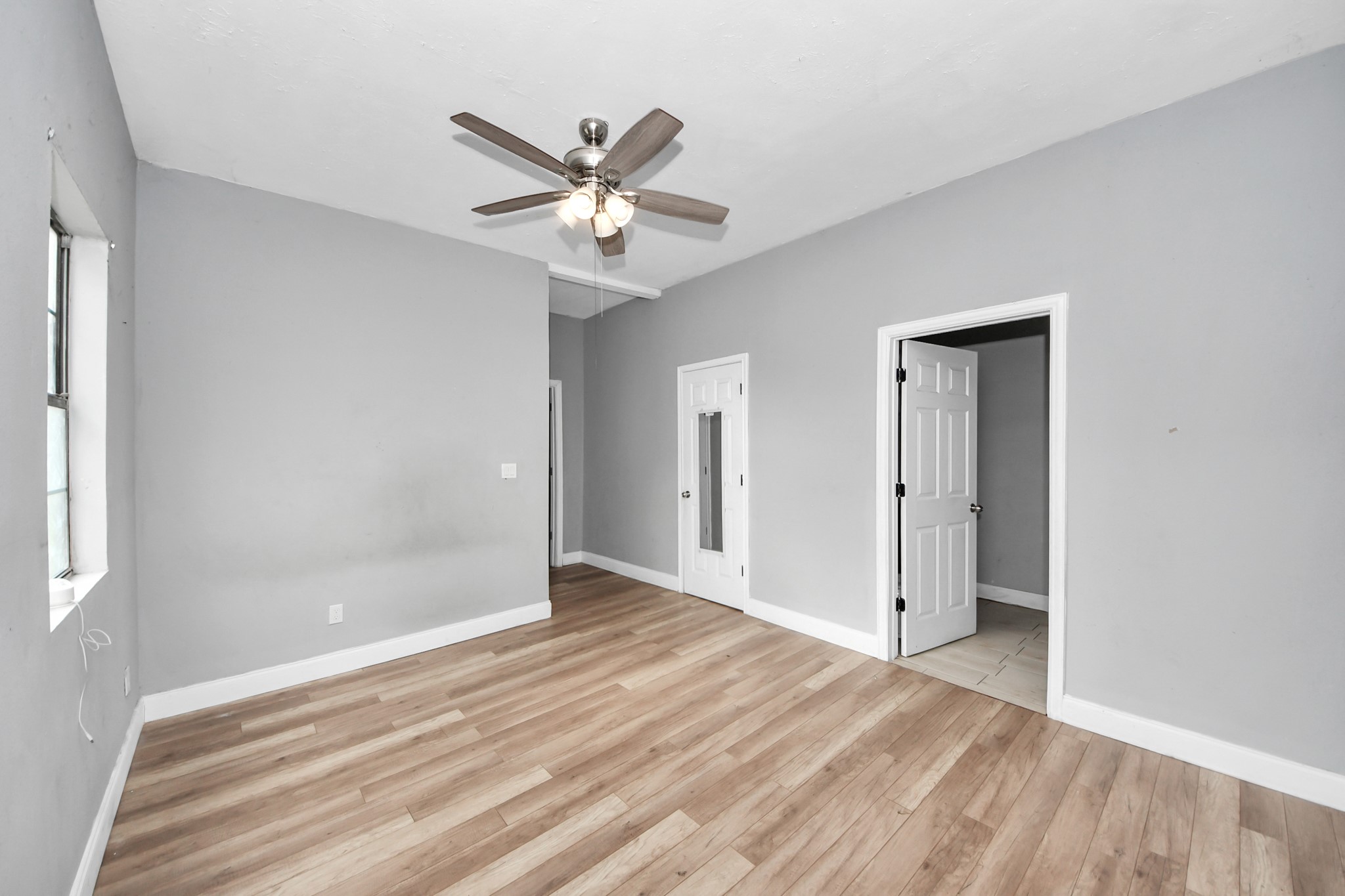 15 High Street Baytown, TX 77520 - Photo 15 of 29 a view of a room with wooden floor and a ceiling fan