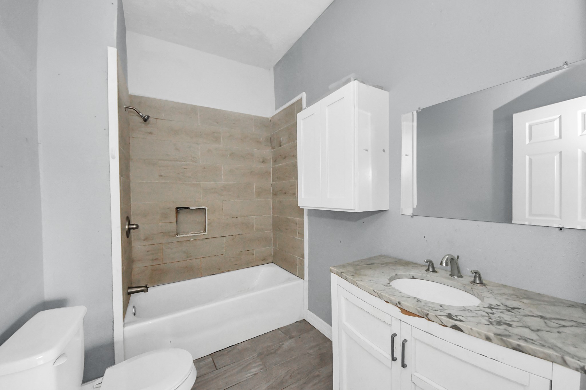 15 High Street Baytown, TX 77520 - Photo 23 of 29 a bathroom with a granite countertop sink toilet and bathtub