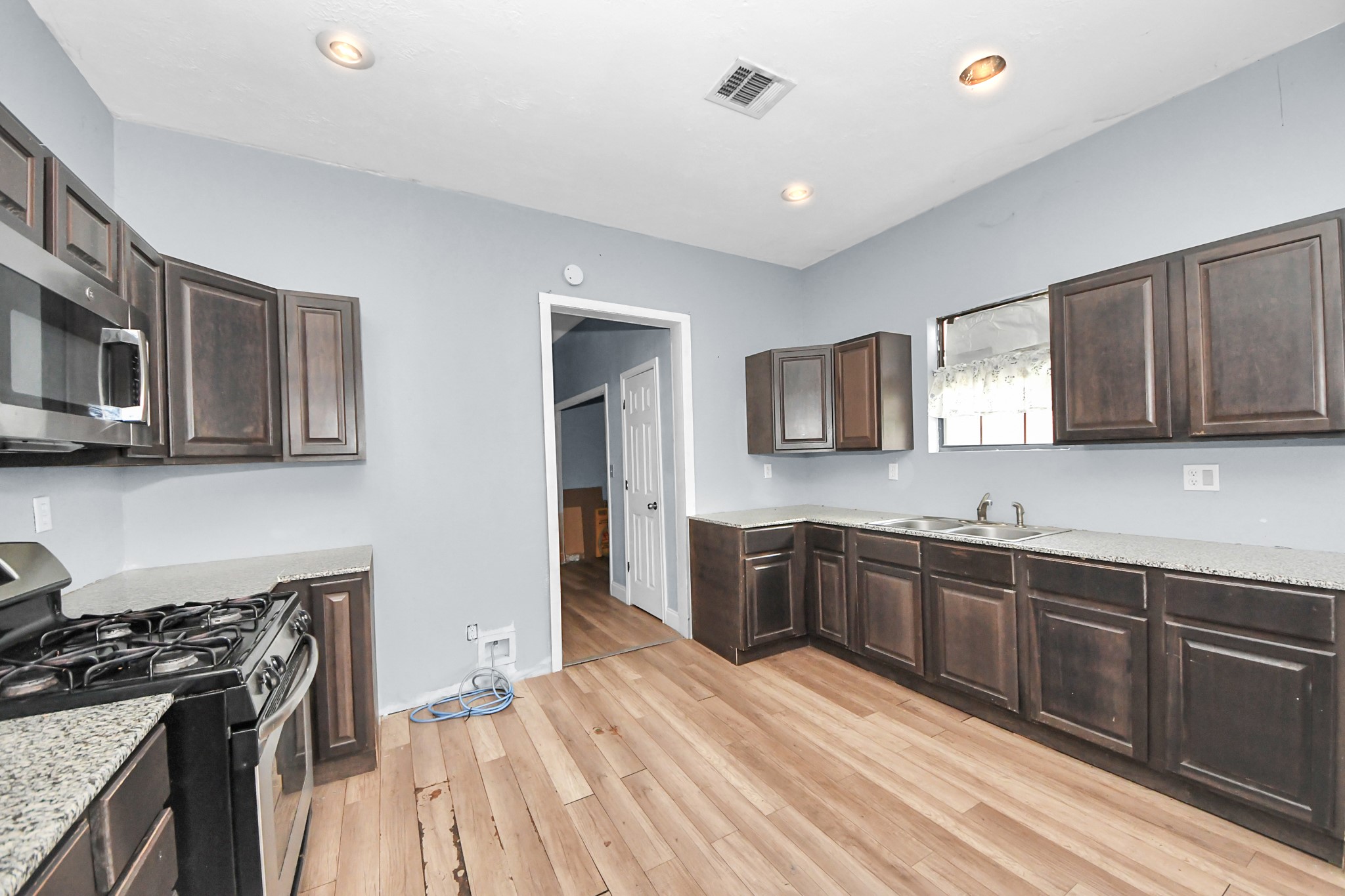 15 High Street Baytown, TX 77520 - Photo 7 of 29 a kitchen with stainless steel appliances granite countertop wooden cabinets a stove top oven a sink and dishwasher