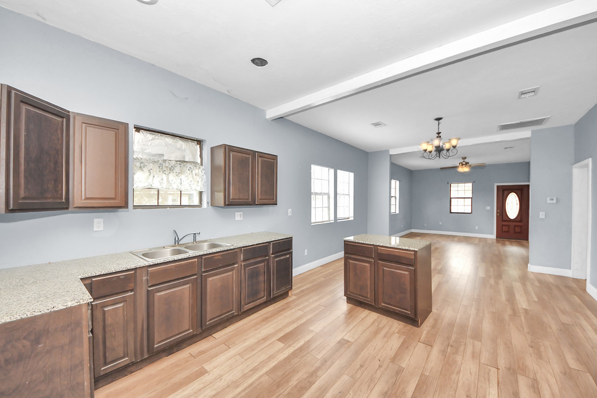 15 High Street Baytown, TX 77520 - Photo 10 of 29 a large kitchen with wooden floors and stainless steel appliances