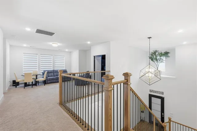 a living room with furniture and large windows