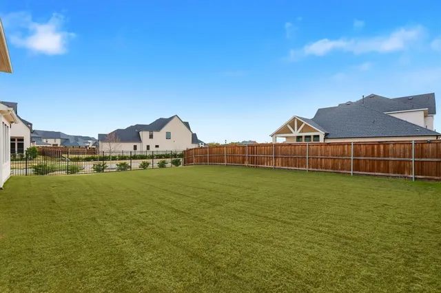 an aerial view of residential houses with yard