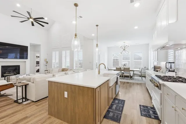 a large kitchen with a counter space a sink stainless steel appliances and cabinets