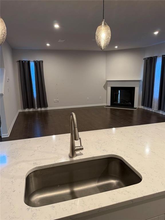 230 Mackenzie Court Covington, GA 30016 - Photo 11 of 23 a kitchen with a sink and a stove with wooden floor