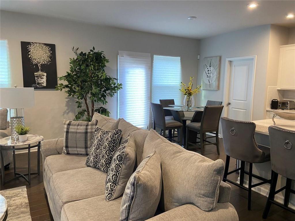 230 Mackenzie Court Covington, GA 30016 - Photo 12 of 23 a living room with furniture potted plant and a window