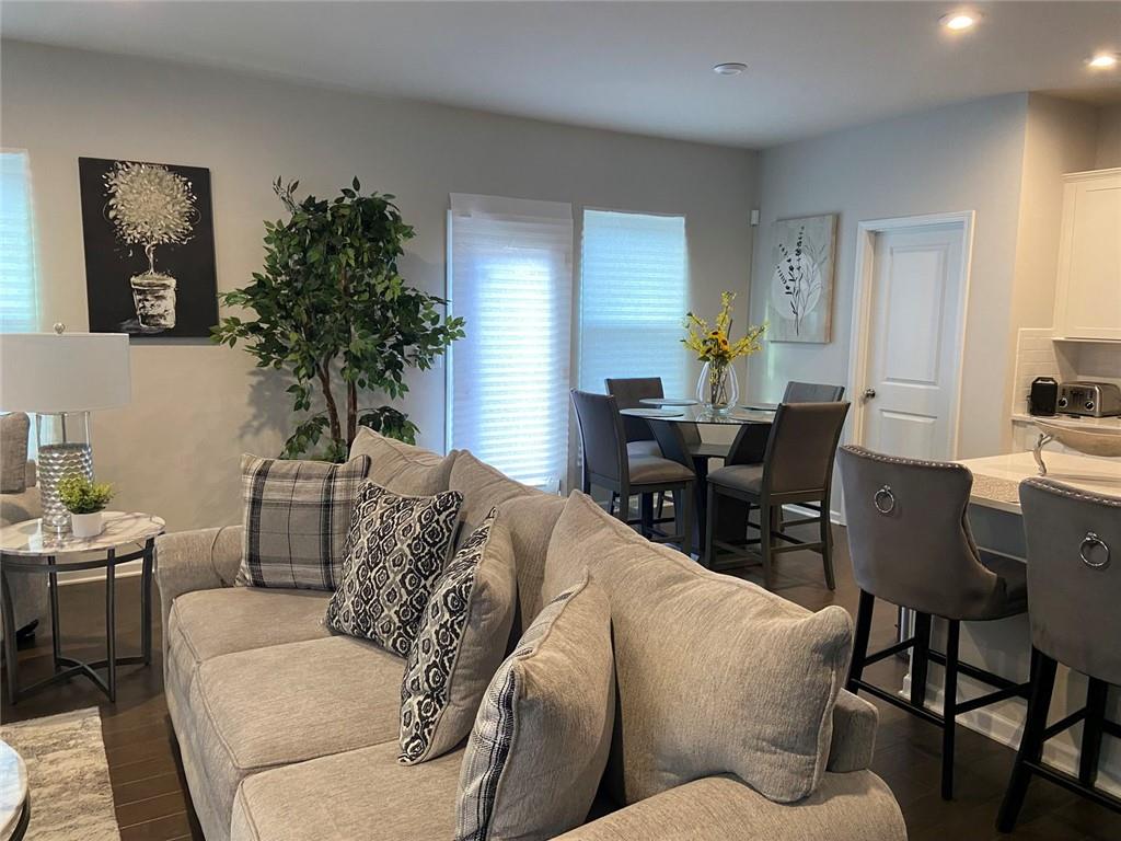 230 Mackenzie Court Covington, GA 30016 - Photo 12 of 23 a living room with furniture potted plant and a window