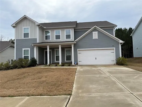 a front view of a house with a yard and garage