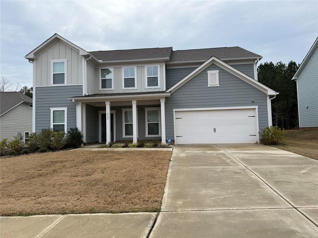 230 Mackenzie Court Covington, GA 30016 - Photo 2 of 23 a front view of a house with a yard and garage