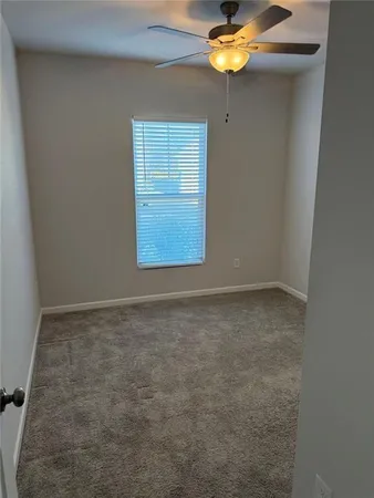 a kitchen that has a lot of white cabinets and stainless steel appliances