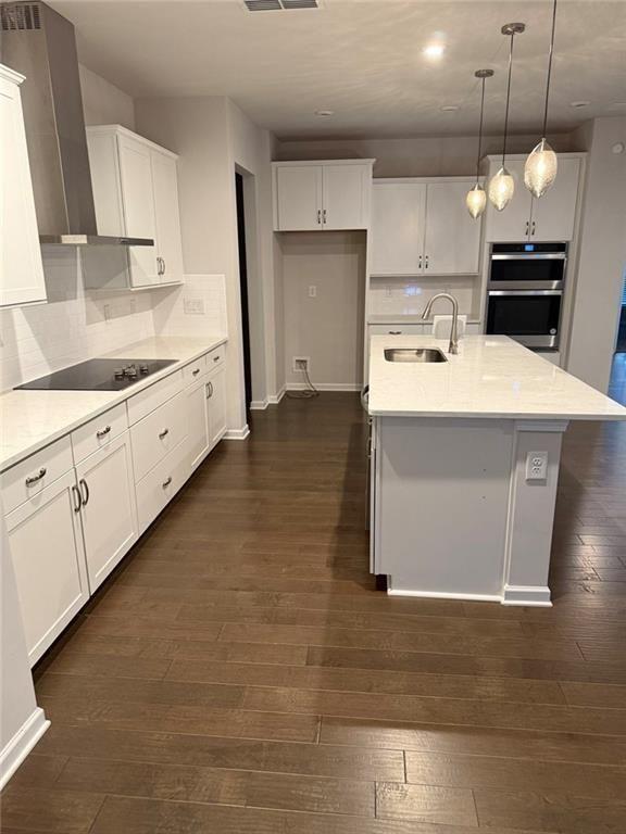 230 Mackenzie Court Covington, GA 30016 - Photo 8 of 23 a kitchen that has a lot of white cabinets and stainless steel appliances