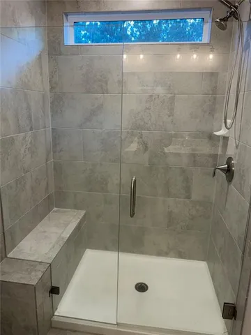 a bathroom with a shower and sink