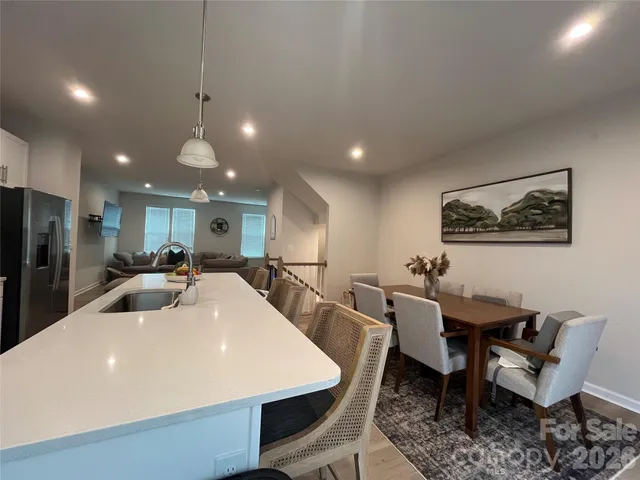 a large kitchen with a table and chairs