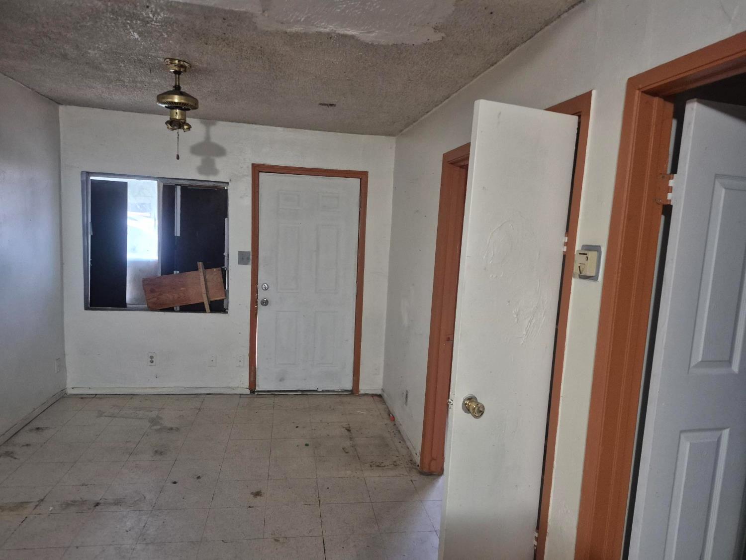 864 East Evening Glow Avenue Reedley, CA 93654 - Photo 2 of 18 a view of a hallway with a chandelier