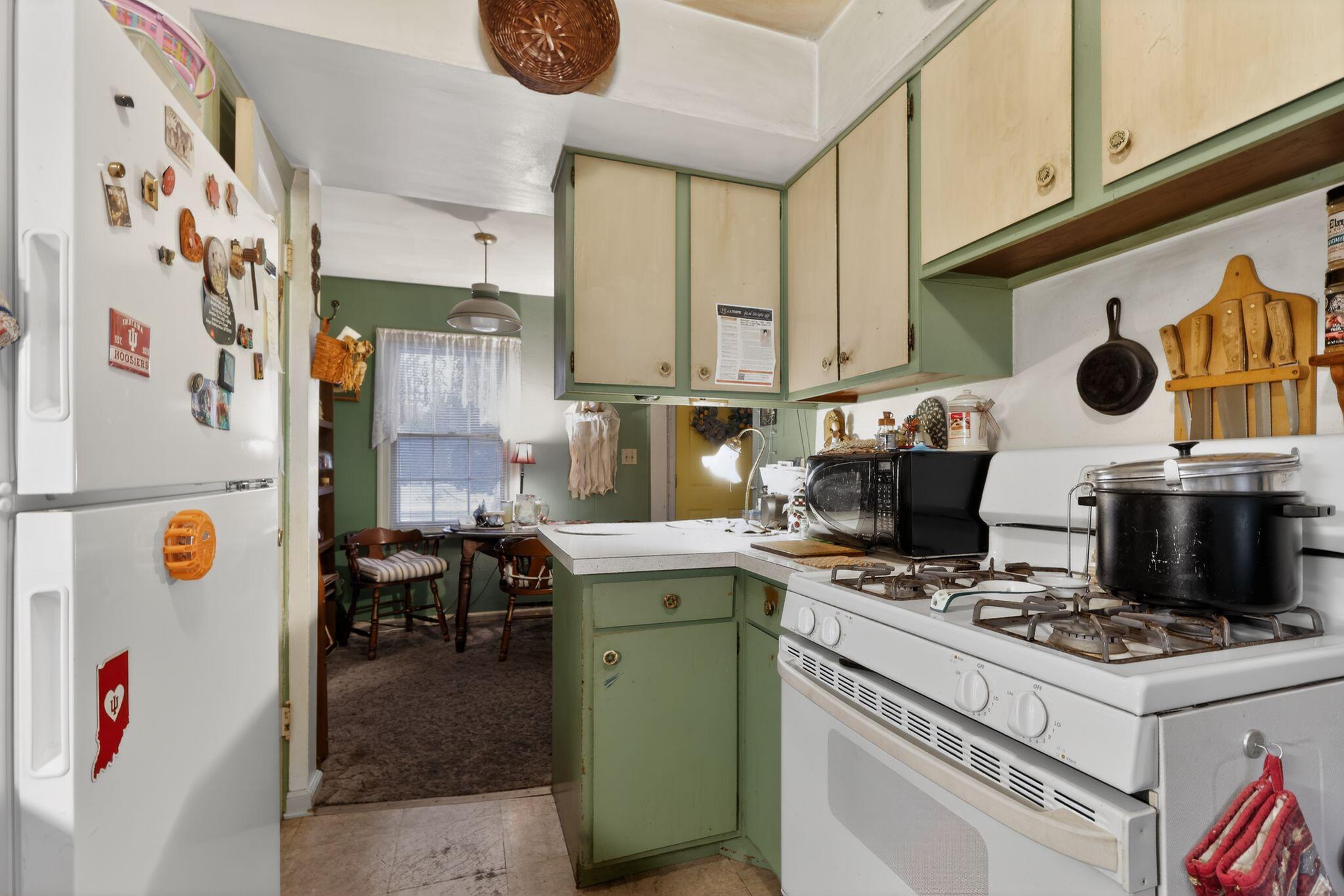 1027 Fox Street La Porte, IN 46350 - Photo 8 of 16 a kitchen with a stove and a refrigerator
