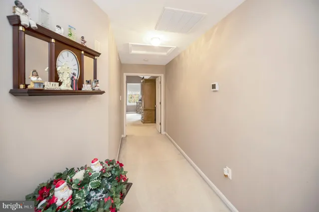 a bed room with a bed mirror and a night stand