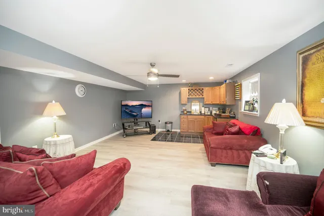 a living room with a table chairs and a wooden floor