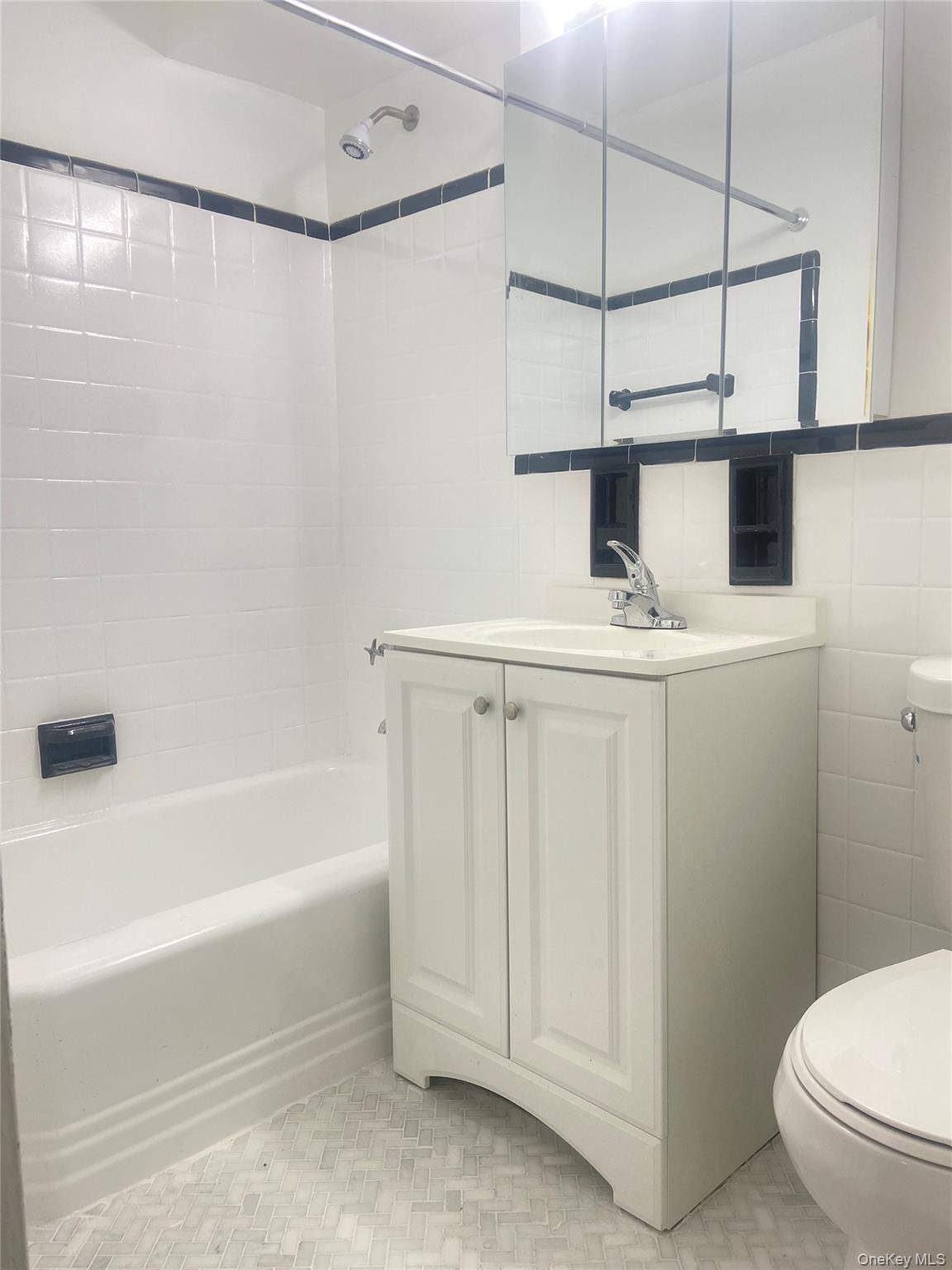 172-70 Highland Avenue, Unit 8P Queens, NY 11432 - Photo 6 of 11 a bathroom with a sink a toilet and shower