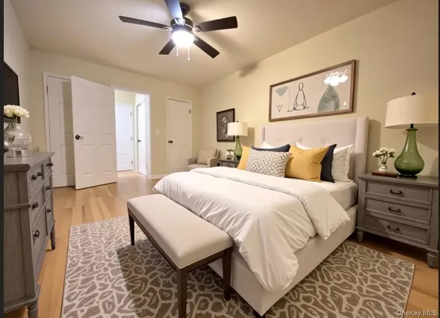 a bedroom with a bed and a lamp on dresser