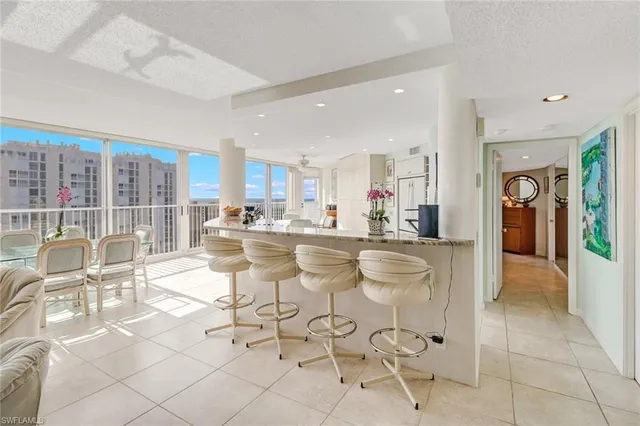 a kitchen with stainless steel appliances kitchen island granite countertop a sink and cabinets