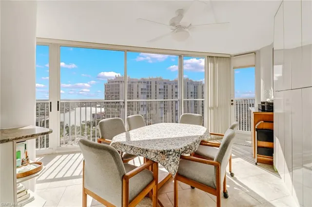 a view of a dining room with furniture large windows and wooden floor