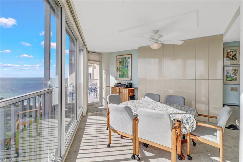 4041 Gulf Shore Boulevard North, Unit PH4 Naples, FL 34103 - Photo 13 of 35 a view of a dining room with furniture and wooden floor