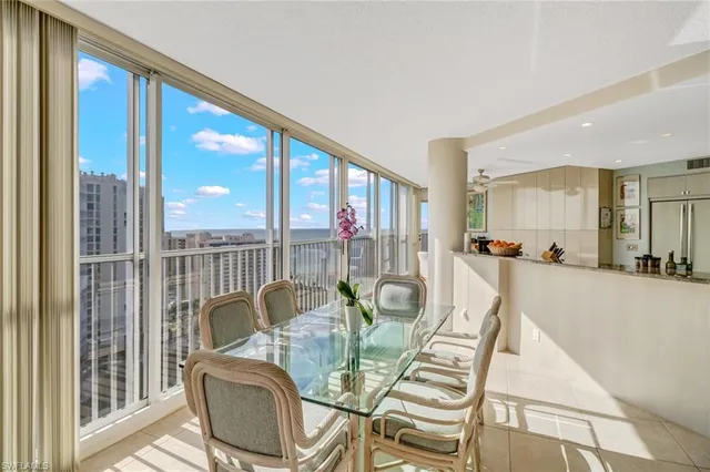 a view of a dining room with furniture water view and wooden floor