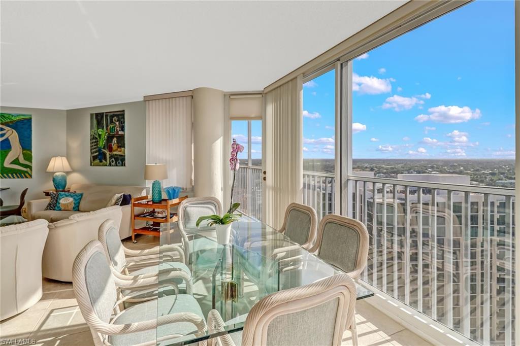 4041 Gulf Shore Boulevard North, Unit PH4 Naples, FL 34103 - Photo 15 of 35 a dining room with furniture water view and large windows