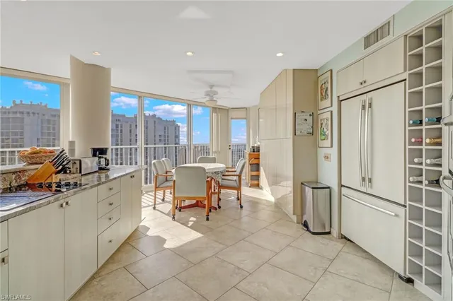 a very nice looking room with a large window and chairs