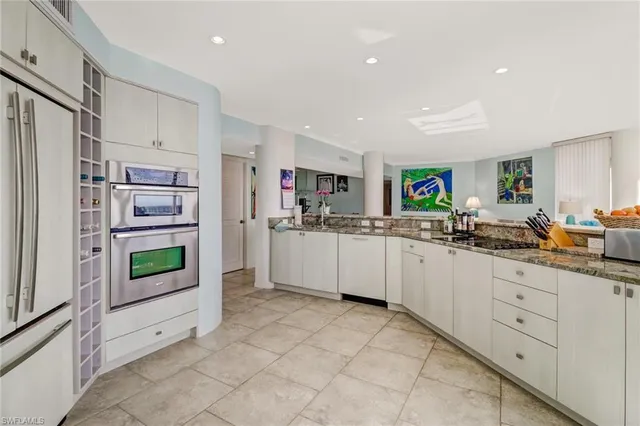 a kitchen with stainless steel appliances a refrigerator and window