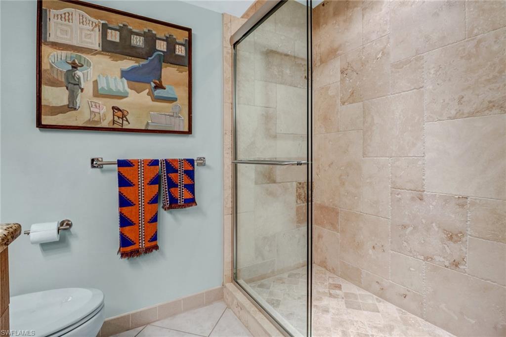 4041 Gulf Shore Boulevard North, Unit PH4 Naples, FL 34103 - Photo 19 of 35 a bathroom with a toilet and a shower