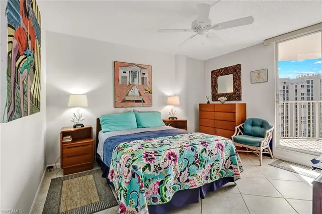 a bedroom with bed and a painting on the wall