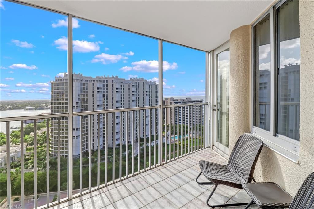 4041 Gulf Shore Boulevard North, Unit PH4 Naples, FL 34103 - Photo 2 of 35 a view of a balcony with furniture