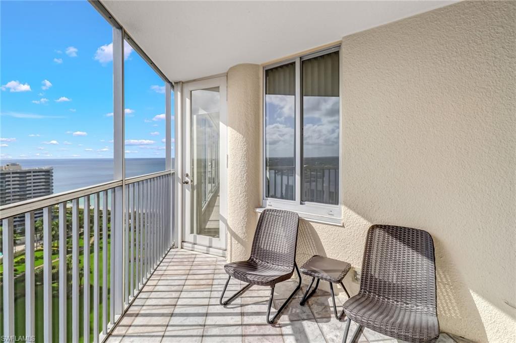 4041 Gulf Shore Boulevard North, Unit PH4 Naples, FL 34103 - Photo 21 of 35 a view of a balcony with chair and table