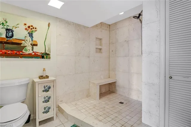 a bathroom with a toilet a sink and shower