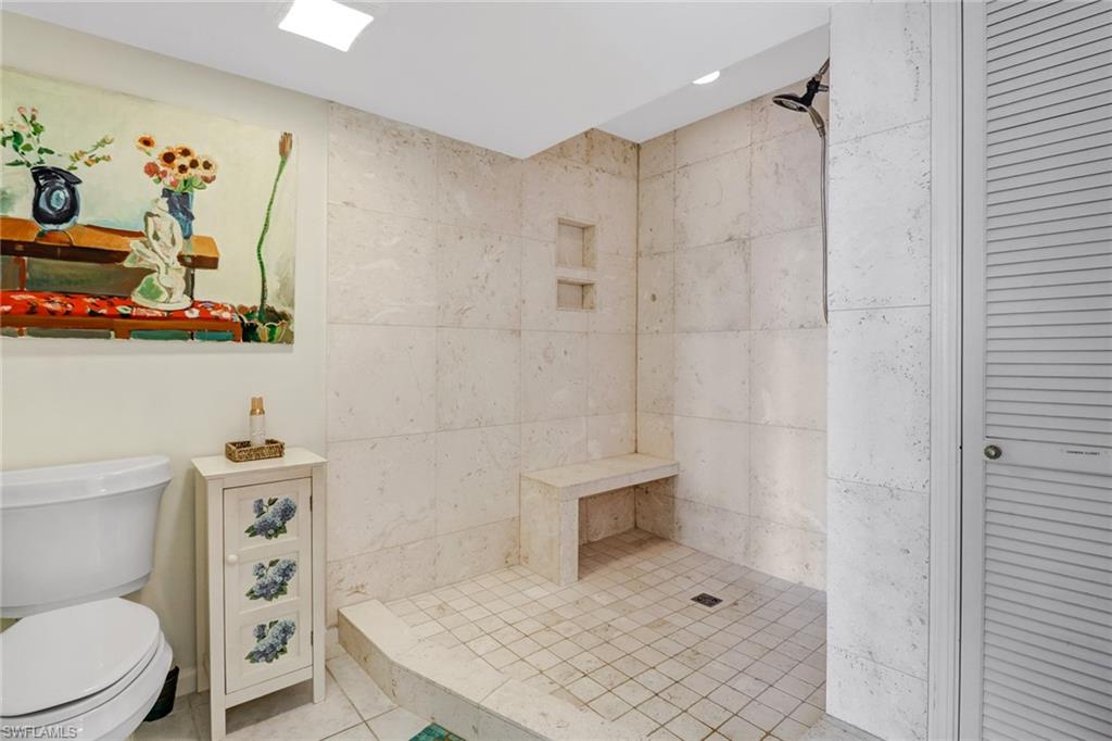4041 Gulf Shore Boulevard North, Unit PH4 Naples, FL 34103 - Photo 25 of 35 a bathroom with a toilet a sink and shower