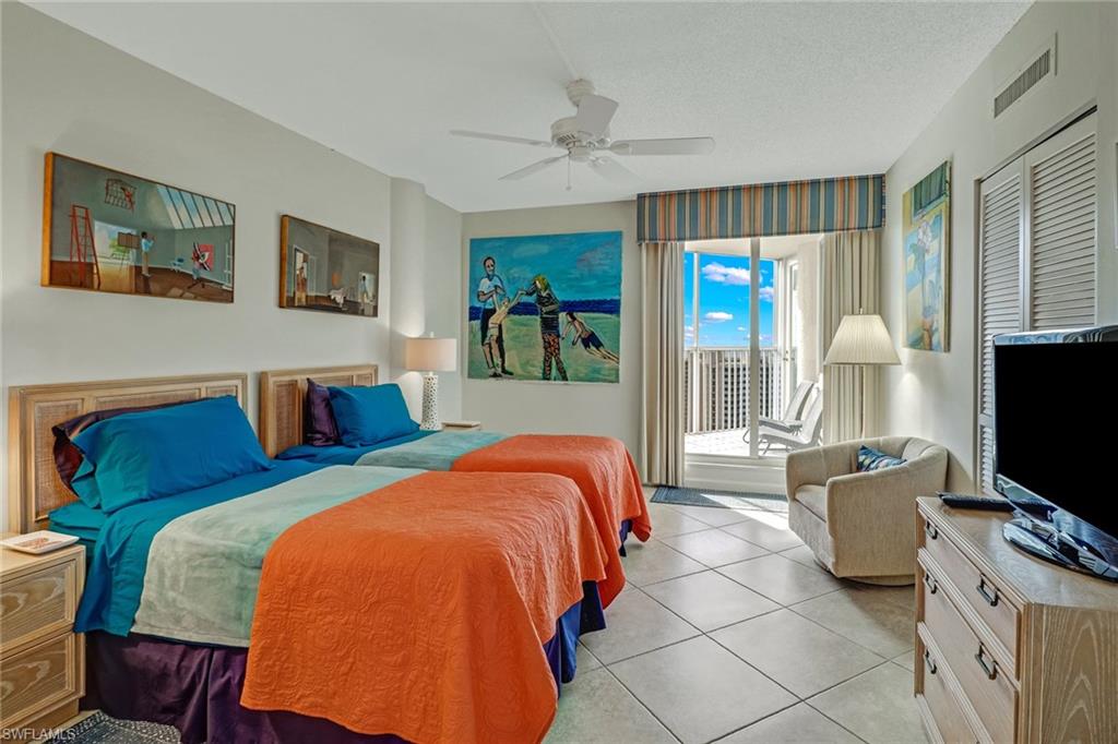 4041 Gulf Shore Boulevard North, Unit PH4 Naples, FL 34103 - Photo 26 of 35 a bedroom with a bed and flat screen tv
